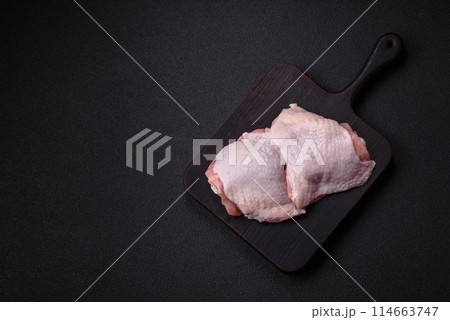 Raw chicken thighs with salt, spices and herbs Raw chicken thighs with salt, spices and herbs 114663747