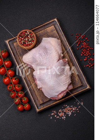 Raw chicken thighs with salt, spices and herbs Raw chicken thighs with salt, spices and herbs 114664077