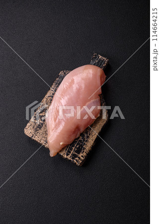 Raw chicken fillet with salt, spices and herbs Raw chicken fillet with salt, spices and herbs 114664215
