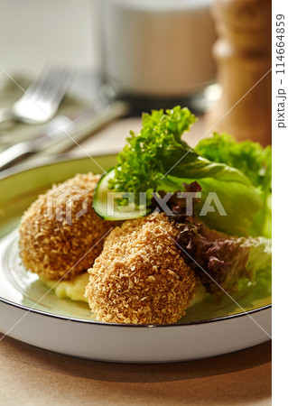Breaded chicken patties with mashed potatoes and greens Breaded chicken patties with mashed potatoes and greens 114664859