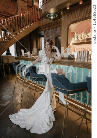 A young couple in wedding looks posing in a stylish loft bar. 114665023