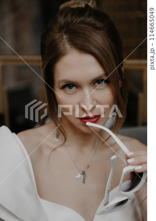 A young couple in wedding looks posing in a stylish loft bar. A young couple in wedding looks posing in a stylish loft bar. 114665049