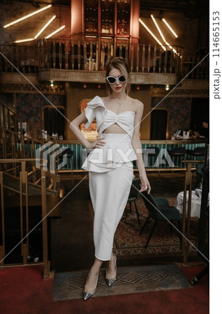 A young couple in wedding looks posing in a stylish loft bar. 114665153