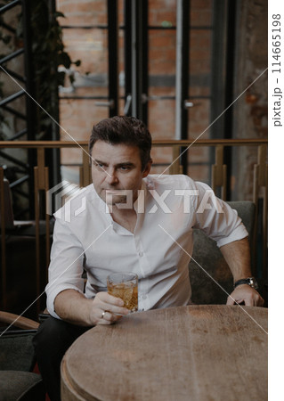 A young couple in wedding looks posing in a stylish loft bar. 114665198