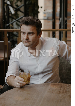 A young couple in wedding looks posing in a stylish loft bar. 114665199