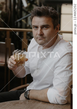A young couple in wedding looks posing in a stylish loft bar. 114665202