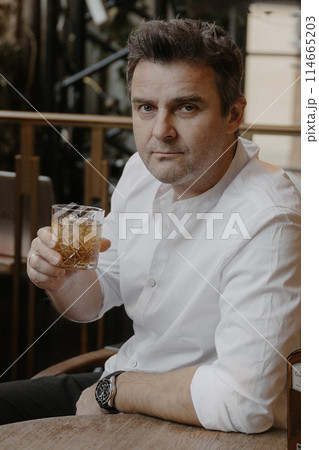A young couple in wedding looks posing in a stylish loft bar. 114665203