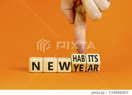New year and habits symbol. Concept word New year New habits on wooden cubes. Beautiful orange table orange background. Psychologist hand. Psychological new year and habits concept. Copy space. New year and habits symbol. Concept word New year New habits on wooden cubes. Beautiful orange table orange background. Psychologist hand. Psychological new year and habits concept. Copy space. 114666807