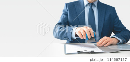 Businessman hand stamping on document at desk 114667137