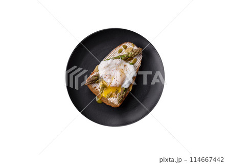 Delicious hearty breakfast consisting of poached eggs on toast with cream cheese, asparagus Delicious hearty breakfast consisting of poached eggs on toast with cream cheese, asparagus 114667442