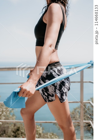 Woman sea pilates. Sporty happy middle aged woman practicing fitness on beach near sea, smiling active female training on yoga mat outside, enjoying healthy lifestyle, harmony and meditation. Woman sea pilates. Sporty happy middle aged woman practicing fitness on beach near sea, smiling active female training on yoga mat outside, enjoying healthy lifestyle, harmony and meditation. 114668133