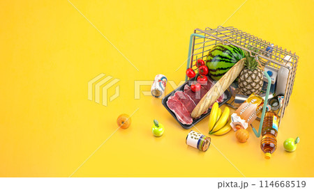 Overturned shopping basket full of variety of grocery products, food and drink ion yellow background. 114668519