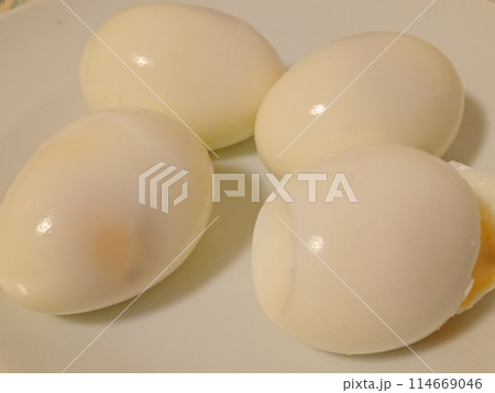 four peeled boiled eggs ready to eat on a white plate 114669046