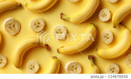 A vibrant pattern of whole and sliced bananas on a yellow background, showcasing the healthy and delicious fruit in an artistic manner. 114670038