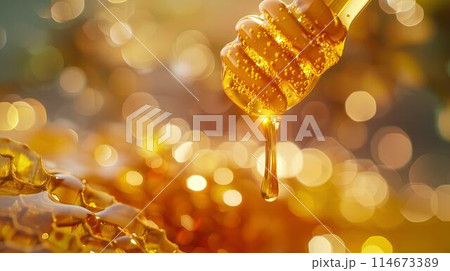 Honey dripping from the wooden honey dropper over thick golden honeycomb on a blurred background. A close up view of the natural organic sweet product. Honey dripping from the wooden honey dropper over thick golden honeycomb on a blurred background. A close up view of the natural organic sweet product. 114673389