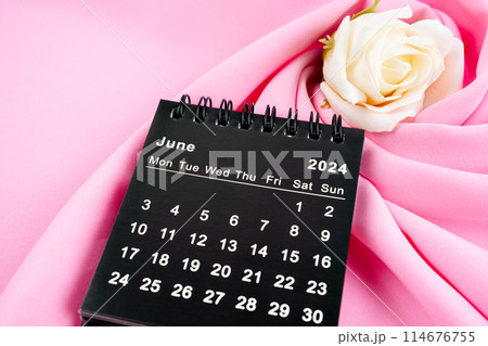 June 2024 desk calendar black color and rose on pink textile. June 2024 desk calendar black color and rose on pink textile. 114676755