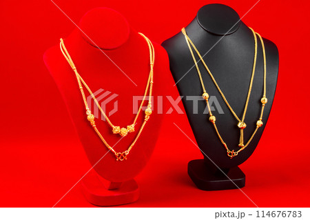 The Accessory and gold jewelry necklace display stand with gold necklace on red Velvet fabric. The Accessory and gold jewelry necklace display stand with gold necklace on red Velvet fabric. 114676783