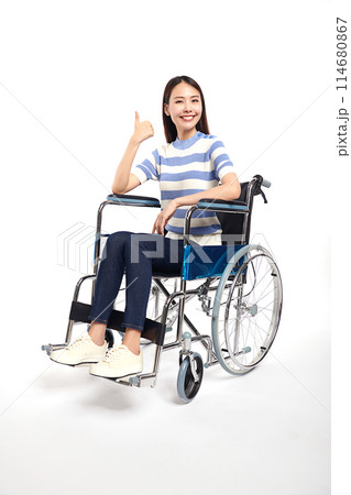 Beautiful young asian with happy smiling woman in a wheelchair on white background, healthcare concept, accident, insurance, life insurance, wellness, hospital. 114680867