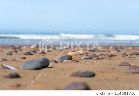 Colored Pebble Beach Texture Background, Sand and Rocky Shore Pattern, Red Morocco Beach, Africa 114681710
