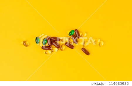 Color Pill Capsules on Yellow Background, Analgesic Pile, Transparent Painkiller Drugs Mix, Sedative Pills Color Pill Capsules on Yellow Background, Analgesic Pile, Transparent Painkiller Drugs Mix, Sedative Pills 114683926