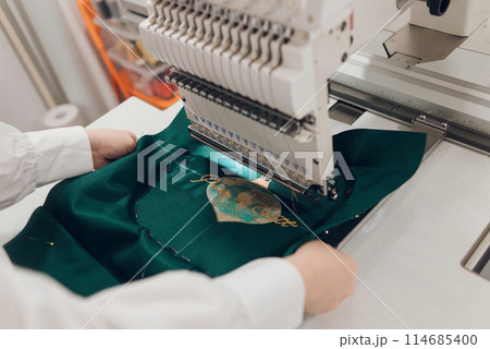 Embroidery machine needle in Textile Industry at Garment Manufacturers, Embroidery T-shirt in progress, Needle with thread Embroidery machine needle in Textile Industry at Garment Manufacturers, Embroidery T-shirt in progress, Needle with thread 114685400