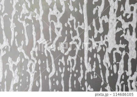 car cleaning and washing with foam soap on the gray car background 114686105