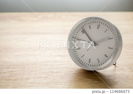 Silver alarm clock on wood table background 114686873