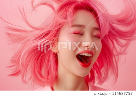 Laughing woman with flowing pink hair, eyes closed in bliss, set against a matching pink background Laughing woman with flowing pink hair, eyes closed in bliss, set against a matching pink background 114687758