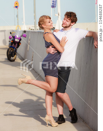 Tourist couple in marina with motorcycle 114688287