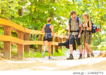 couple backpacker hiking in forest pathway 114688773