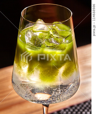 Chilled matcha tonic cocktail in elegant stemmed glass Chilled matcha tonic cocktail in elegant stemmed glass 114688986