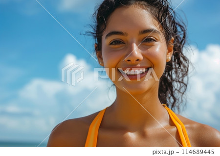Joyful young woman with a radiant smile enjoys a sunny day, exuding happiness and vitality 114689445