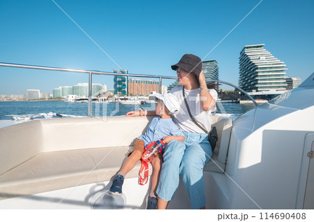Family enjoying a boat ride at Al Raha 114690408