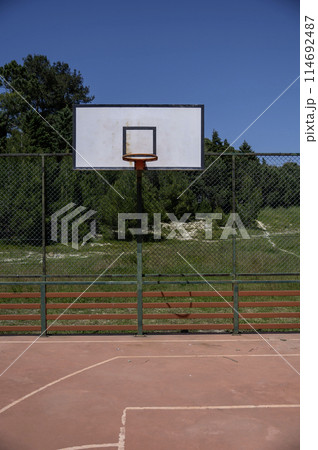basketball hoop in an outdoor court basketball hoop in an outdoor court 114692487