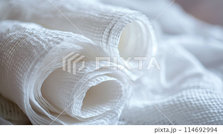 Rolled medical gauze on white. 114692994
