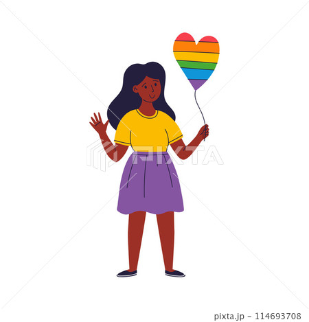 A young woman is holding a rainbow-colored heart balloon A young woman is holding a rainbow-colored heart balloon 114693708