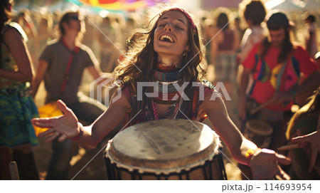 a festival-goer reveling in the vibrant energy of a drum circle, their hands beating out a rhythmic cadence 114693954