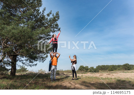 Tourists catching cellular network signal in forest. 114695175