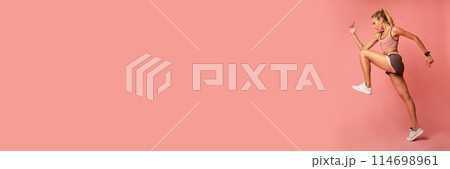 Workout Concept. Determined Fitness Lady Jumping Exercising On Pink Studio Background. Copy Space, Side View, Web-banner 114698961