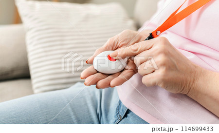Emergency call system. Senior woman pressing Alarm Button, closeup Emergency call system. Senior woman pressing Alarm Button, closeup 114699433