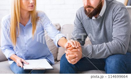 Psychological help and assistance. Female specialist supporting depressed patient at personal therapy in office 114699664