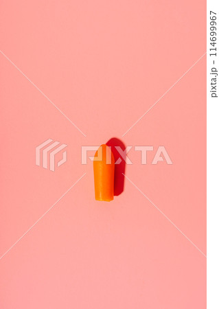 Unpacked red rectal candle on a pink background 114699967
