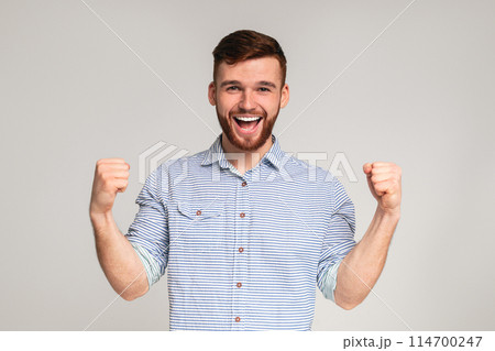 Cheerful guy showing his biceps and smiling on studio background, panorama, copy space Cheerful guy showing his biceps and smiling on studio background, panorama, copy space 114700247