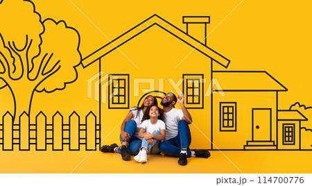 Dreaming African American family father mother and child sitting on floor over drawn on yellow wall house. Mortgage, real estate concept Dreaming African American family father mother and child sitting on floor over drawn on yellow wall house. Mortgage, real estate concept 114700776