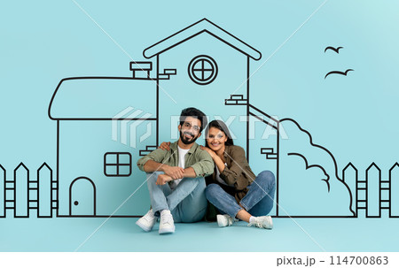 Indian man and woman are sitting next to each other in front of a drawing. They appear engaged in conversation or contemplation. The drawing, not fully visible, seems to be intricate and detailed. Indian man and woman are sitting next to each other in front of a drawing. They appear engaged in conversation or contemplation. The drawing, not fully visible, seems to be intricate and detailed. 114700863