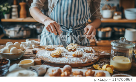 Artisan baker applies frosting on delicious cupcakes in a warm, rustic home kitchen filled with various baking ingredients and utensils Artisan baker applies frosting on delicious cupcakes in a warm, rustic home kitchen filled with various baking ingredients and utensils 114700967