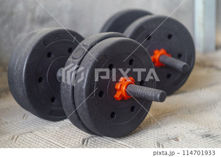 Black dumbbells with pancakes of 3 and 2 kilograms. Sports equipment for strength training 114701933