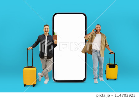 Businessman and traveler with suitcases beside a giant smartphone, indicating online travel technology, isolated on a turquoise background 114702923