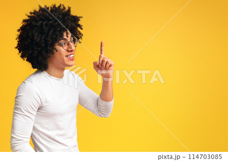 Got problem solution. Profile portrait of black inspired guy pointing finger up, orange panorama background with empty space Got problem solution. Profile portrait of black inspired guy pointing finger up, orange panorama background with empty space 114703085