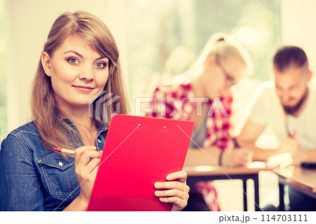 Student girl in front of her mates in classroom 114703111